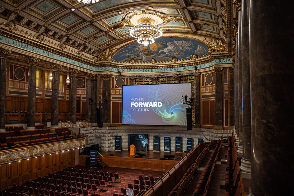 Row seating in front of a large screen