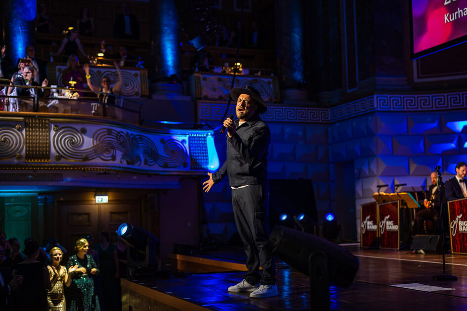 A man sings on stage