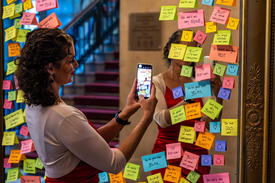 A woman takes a selfie in front of the mirror