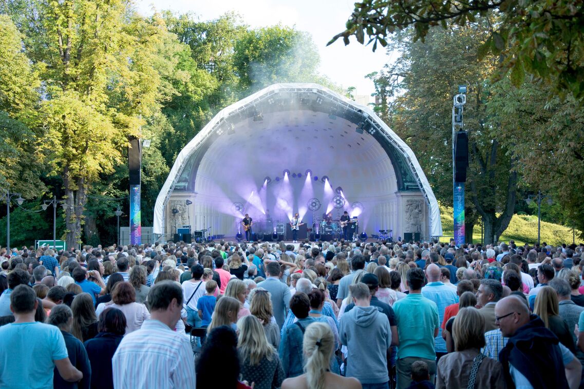 Concert area with concert shell in the spa gardens - concert with show effects in front of a standing audience