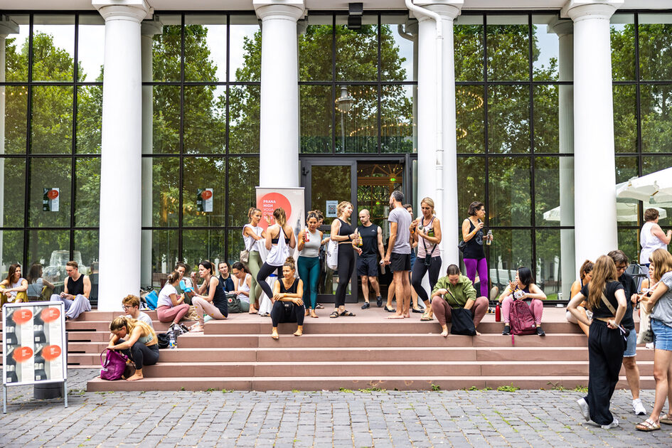 Event guests take a break and sit by the stairs