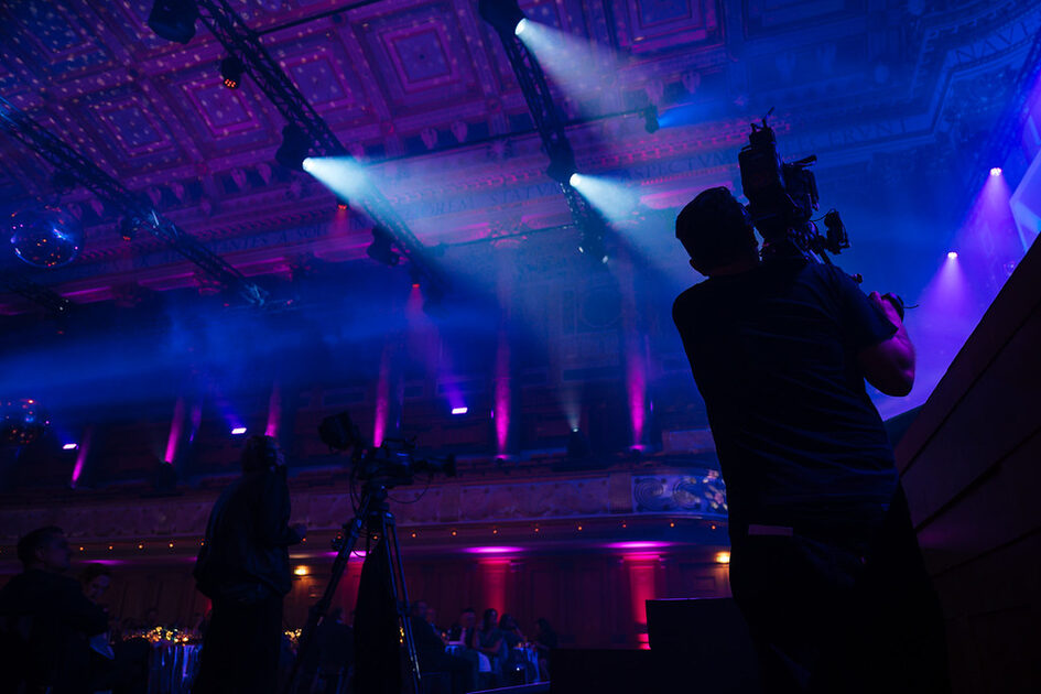 A cameraman during an afterparty in the Friedrich von Thiersch Saal in the Kurhaus