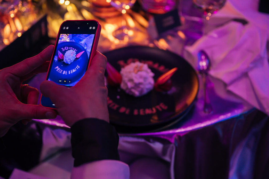 A guest takes a photo of the plate with the food