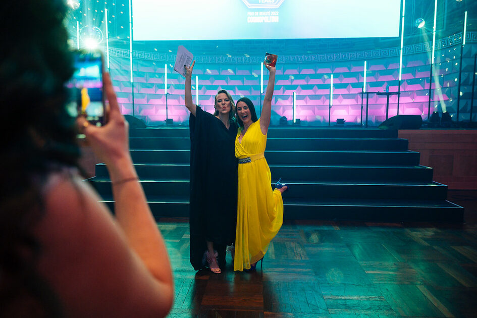 Two women with the prize in front of the stage