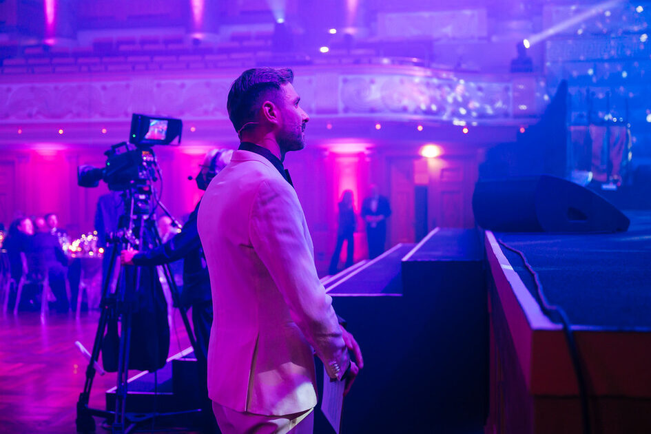 A man stands in front of the stage