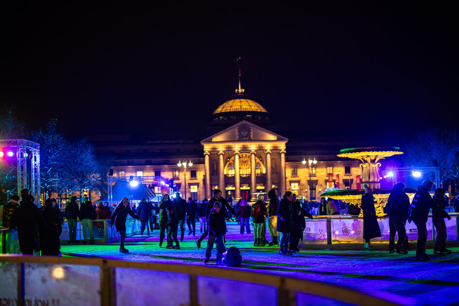 People on the ice rink in front of the Kurhaus
