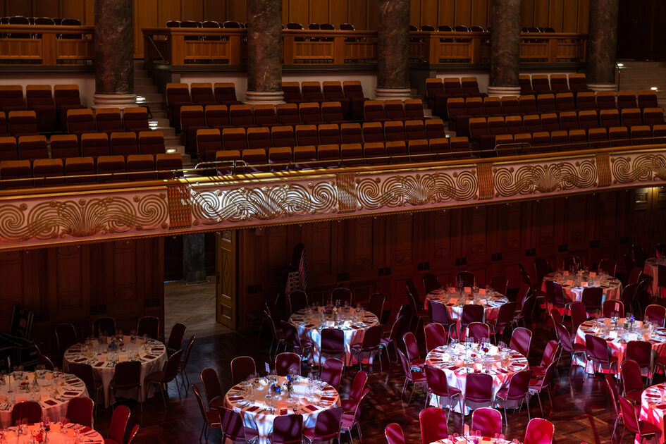 Gala seating (white-covered tables and chairs) in the Kurhaus
