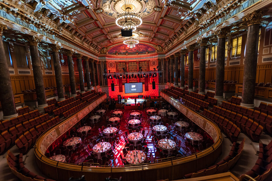 Gala seating (white-covered tables and chairs) in the Kurhaus